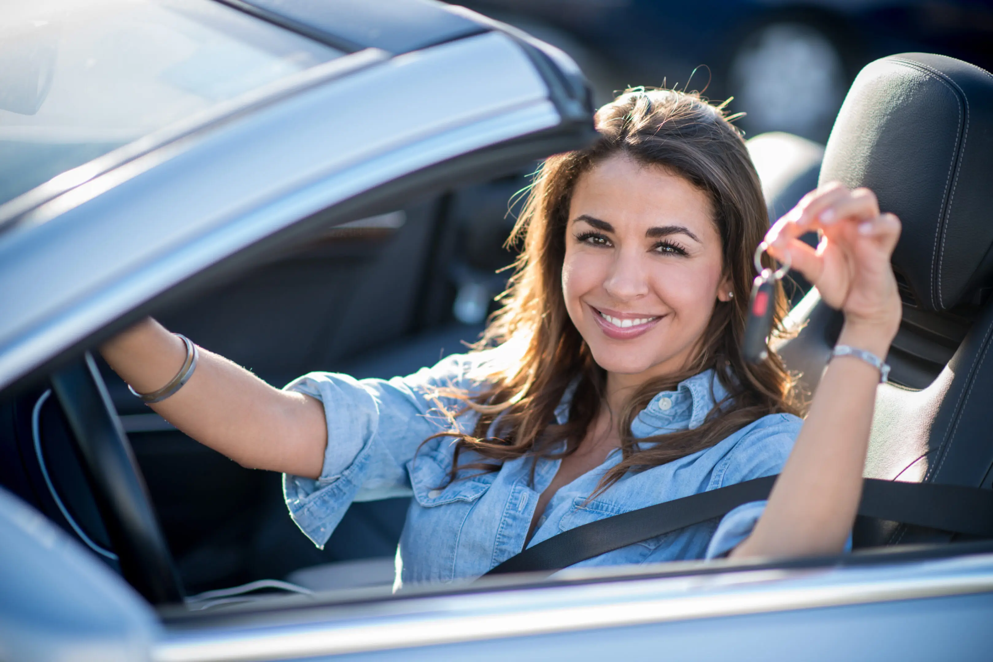 Woman holding car keys Woman holding car keys and looking very happy